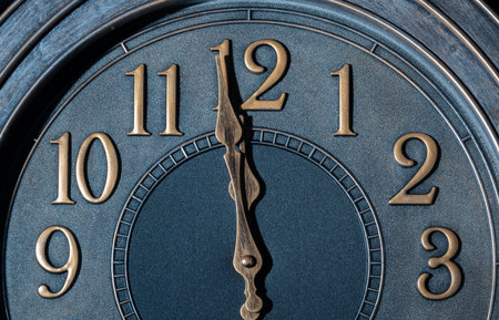 Retro style clock with gold like numbers showing one minute to midnight.