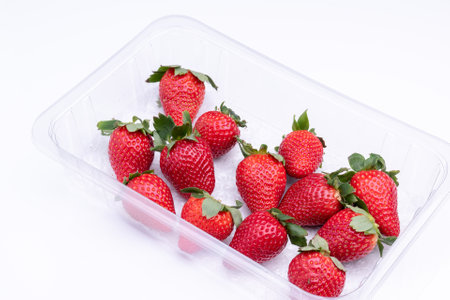 Fresh strawberries in plastic punet, ready to be consumedの写真素材