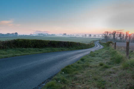 Sunrise in Ireland, country site landscape photography with blue sky and fog over the horizone.の写真素材