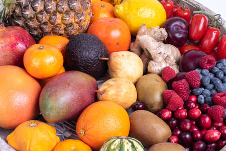 fresh vegetables and fruits isolated on a white background in wooden tray.の写真素材