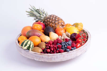 fresh vegetables and fruits isolated on a white background in wooden tray.の写真素材