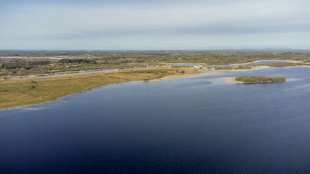 Aerial view of a forest lake. Drone photography. Forest and lake border. Coastline view from the drone.の写真素材