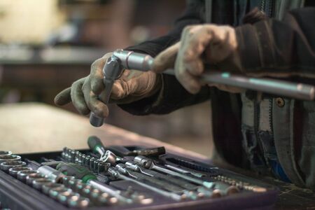 Workshop worker holding wrenches in his handsの写真素材