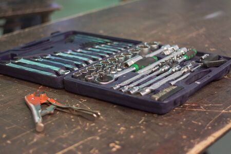 Open wrench set on old brown tableの写真素材