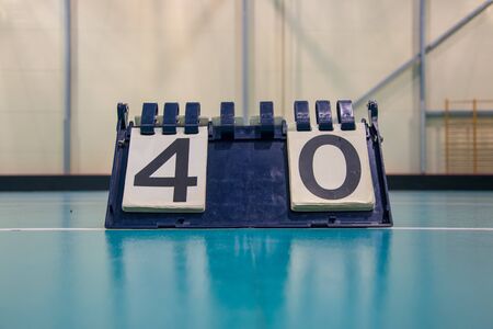 Score board inside the gym on the floor shows result 4:0の写真素材