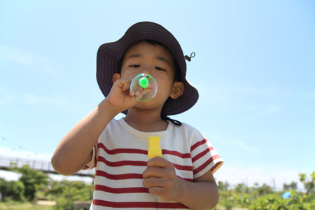 Japanese boy blowing bubbles