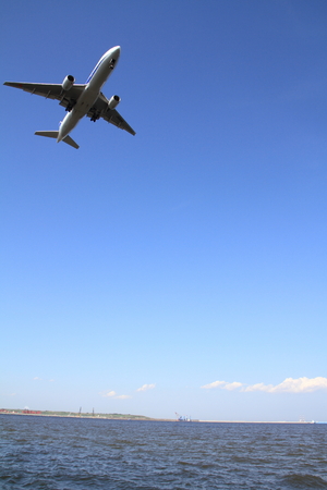 Landing airplane and seaの写真素材