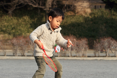 Japanese boy playing badmintonの写真素材