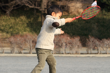 Japanese boy playing badmintonの写真素材