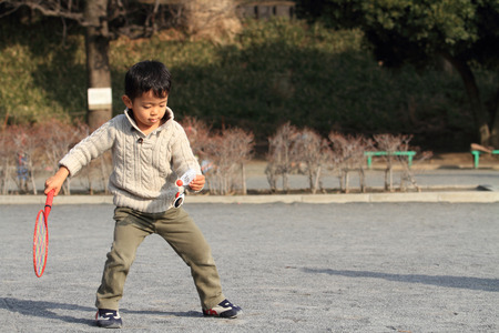 Japanese boy playing badmintonの写真素材