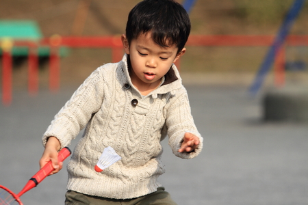 Japanese boy playing badmintonの写真素材
