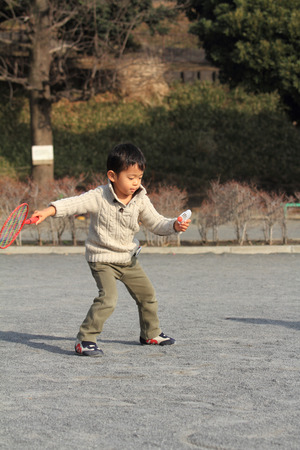 Japanese boy playing badmintonの写真素材