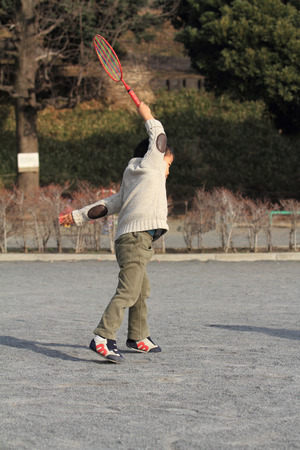 Japanese boy playing badmintonの写真素材