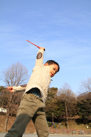 Japanese boy playing badmintonの写真素材