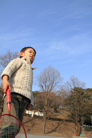 Japanese boy playing badmintonの写真素材