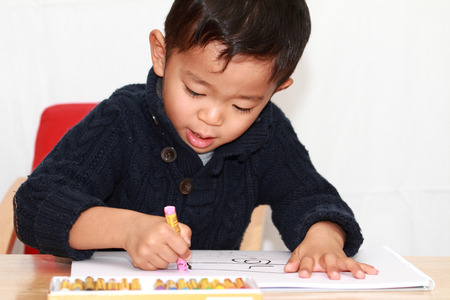 Japanese boy drawing a pictureの写真素材