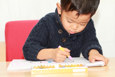 Japanese boy drawing a pictureの写真素材