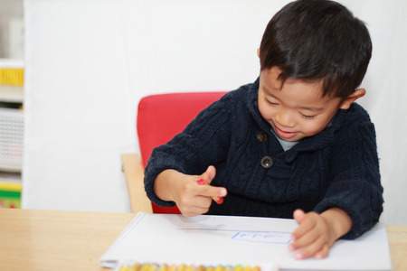 Japanese boy drawing a pictureの写真素材