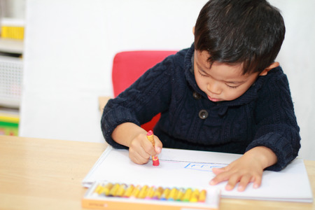 Japanese boy drawing a pictureの写真素材