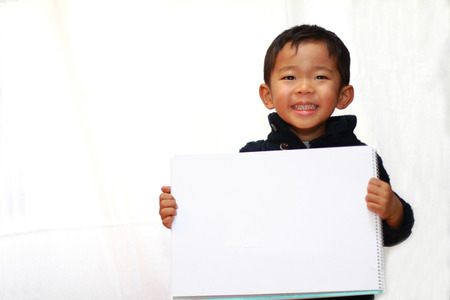 Japanese boy with sketch bookの写真素材