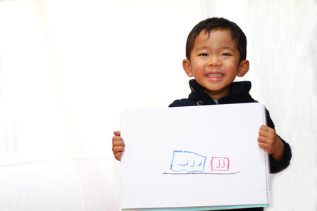 Japanese boy with sketch bookの写真素材