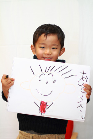 Japanese boy with sketch bookの写真素材
