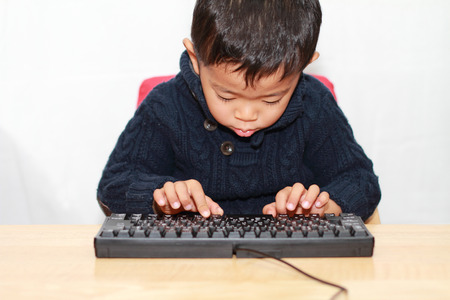 Boy and keyboardの写真素材