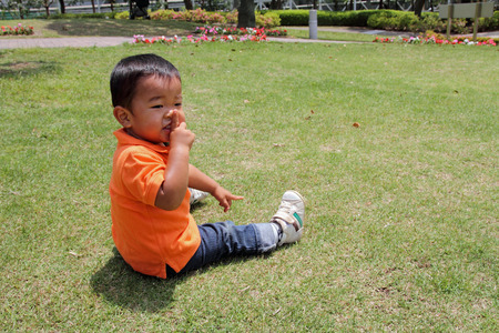Japanese boy sitting on the glassの写真素材