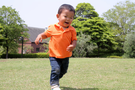 Japanese boy running on the glassの写真素材