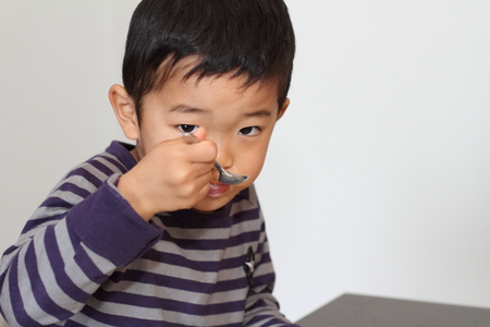 Japanese boy eating cerealの写真素材