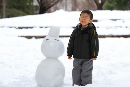 Japanese boy and snowmanの写真素材