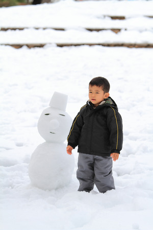 Japanese boy and snowmanの写真素材