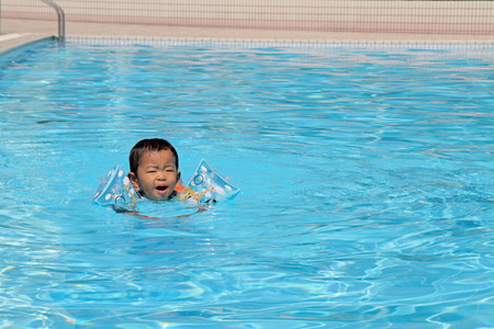 Japanese boy swiming in the pool (1 year old)のeditorial素材