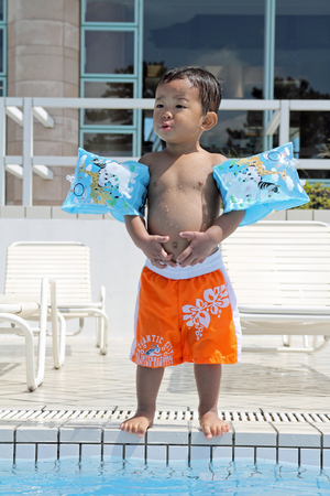 Japanese boy standing on the poolside (1 year old)のeditorial素材