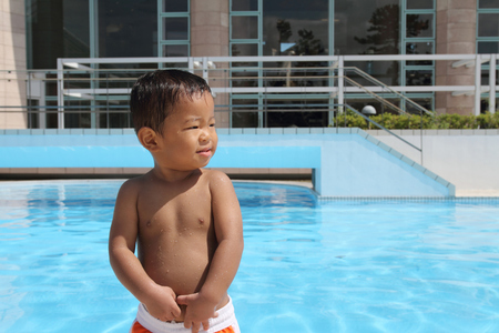 Japanese boy standing on the poolside (1 year old)のeditorial素材