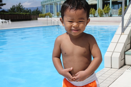Japanese boy standing on the poolside (1 year old)のeditorial素材