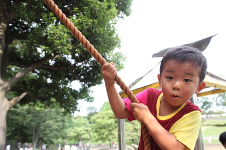 Japanese boy climbing on the wall (3 years old)の写真素材