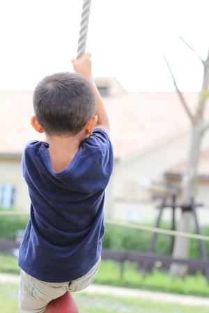 Japanese boy playing with Tarzan rope (4 years old)の写真素材