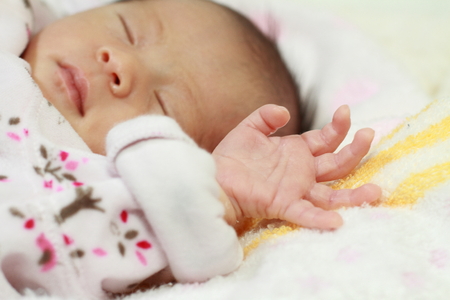 Sleeping newborn baby (Japanese baby girl)の写真素材