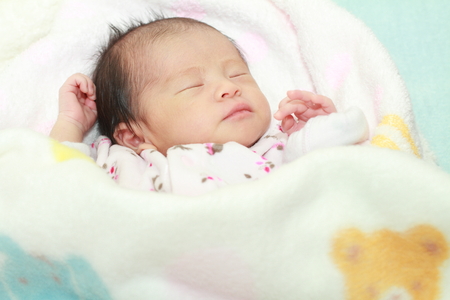 Sleeping newborn baby (Japanese baby girl)の写真素材