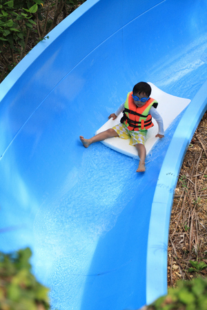 Japanese boy on the water slide 5 years oldの写真素材