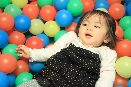 Japanese baby girl playing in ball pool (1 year old)の写真素材