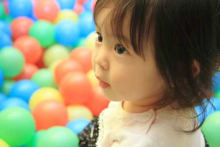 Japanese baby girl playing in ball pool (1 year old)の写真素材
