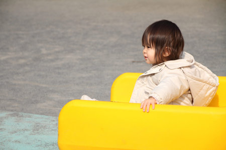 Japanese baby girl on the slide (1 year old)の写真素材