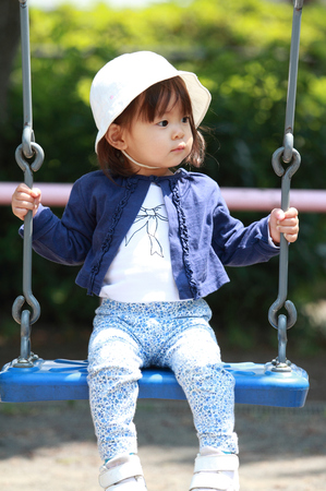 Japanese girl on the swing (1 year old)の写真素材