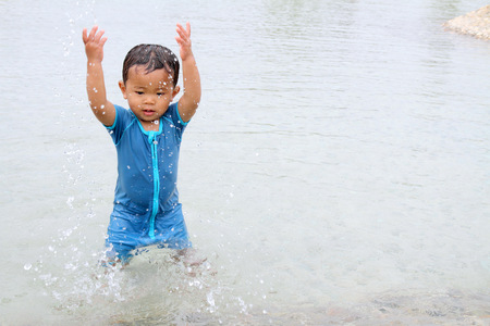 Japanese boy playing with water (1 year old)の写真素材