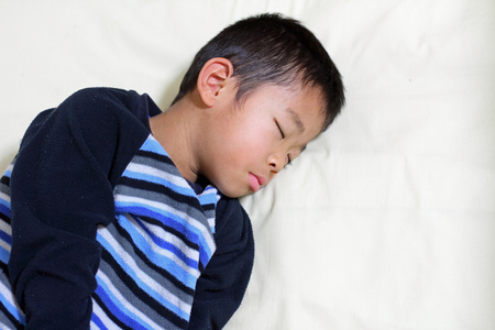 Sleeping Japanese boy (first grade at elementary school)の写真素材