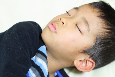 Sleeping Japanese boy (first grade at elementary school)の写真素材