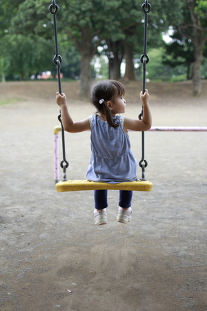 Japanese girl on the swing (2 years old)の写真素材