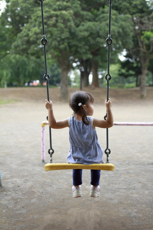 Japanese girl on the swing (2 years old)の写真素材